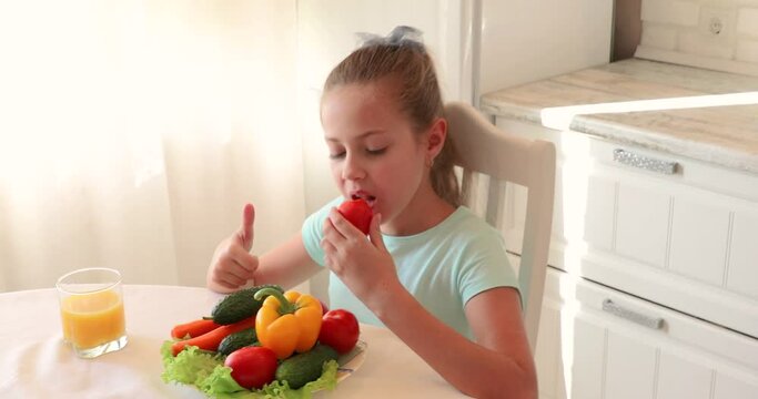 little girl in the kitchen. the child loves vegetables. healthy food concept. vitamins for a child