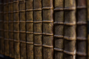 Ancient book collection with brown leather binding. Knowledge background.