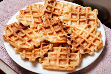 Belgian homemade waffles made from cottage cheese on a white plate.