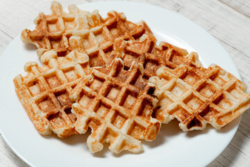 Belgian homemade waffles made from cottage cheese on a white plate.