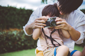 little boy taking photo with mom and dad, happy family.