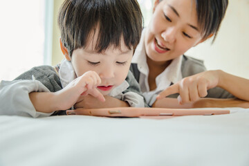 little kids boy cute schoolboy fun and enjoying playing and using digital tablet ,People family learning lifestyle concept.
