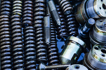 Steel mechanical parts lubricated with machine oil, close-up. Steel nozzles, springs, bushings,...