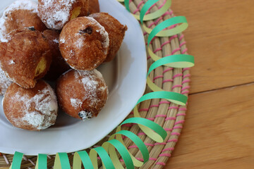 Traditional italian Fritters called Frittelle on a plate with Carnival decorations