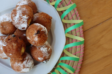 Traditional italian Fritters called Frittelle on a plate with Carnival decorations