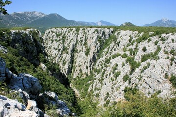 Fototapeta na wymiar the deep Canyon of the Cetina river near Zadvarje and the Great Gubavica waterfall, Croatia