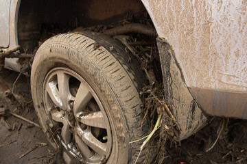 Fototapeta na wymiar A car was dragged and damaged by the flood the effect of heavy rain and deforestation.