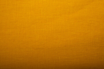 Natural linen fabric texture. Textured yellow fabric background. Concept of using natural eco-friendly materials