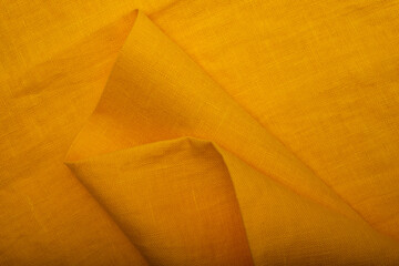 Natural linen fabric texture. Textured yellow fabric background. Concept of using natural eco-friendly materials