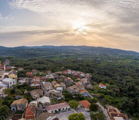Fototapeta na wymiar Aerial drone view of beautiful Agioi douloi village in north corfu grece in sunset time
