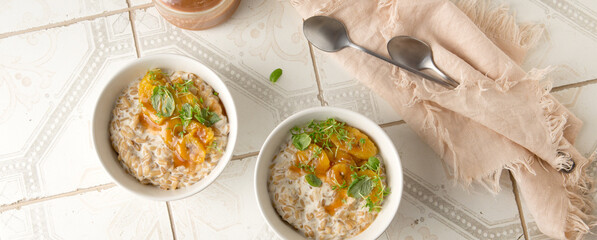 bowls of oatmeal with bananas and salted caramel on a light table