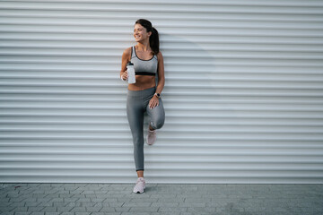  Fit athlete woman in sportswear outdoors. Young woman jogging outside.