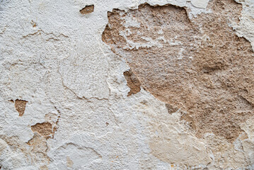 Texture of an old wall with peeling plaster