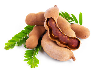 Fototapeta premium Tamarind fruit with green leaves isolated on white background. Famous fruit in Phetchabun province of Thailand.