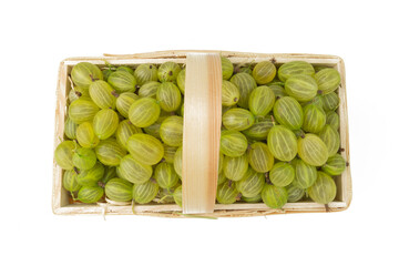 top view on gooseberry in wooden basket isolated on white background