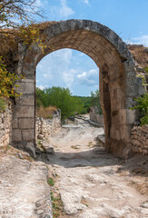 Fototapeta na wymiar Middle Gate of Chufut-Kale in Crimean Mountains, medieval city-fortress, national monument of Karaites, now in ruins Chufut-Kale near Bakhchisarai, central Crimea