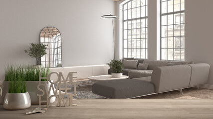 Wooden table, desk or shelf with potted grass plant, house keys and 3D letters home sweet home, modern living room with large sofa, architecture interior design, copy space background
