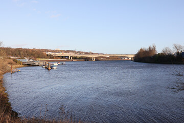 Fototapeta na wymiar Newcastle UK: 31st Jan 2022: Newburn Riverside at the River Tyne, waves on a windy day with the A1 motorway bridge