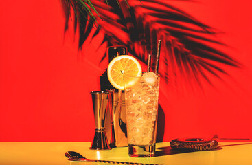 Tom Collins alcoholic cocktail with dry gin, syrup, lemon juice, soda, orange and ice. Defiant red...