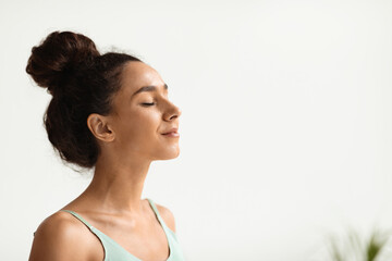 Closeup Portrait Of Peaceful Smiling Young Female Standing With Closed Eyes