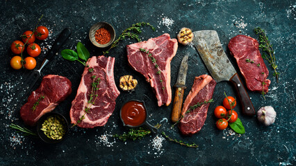 Variety of raw aged beef steaks: t-bone, tomahawk, striploin, tenderloin, new york steak for...
