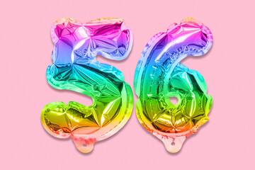 Rainbow foil balloon number, digit fifty six on a pink background. Birthday greeting card with inscription 56. Top view. Numerical digit. Celebration event, template.