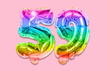 Rainbow foil balloon number, digit fifty nine on a pink background. Birthday greeting card with inscription 59. Top view. Numerical digit. Celebration event, template.