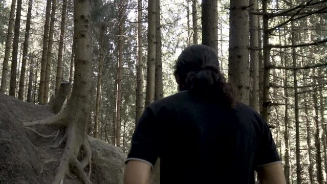 Young beard man in the jungle of deodar, willow, pine and robinia in manali. Young man trekking for joginifalls, Himachal Pradesh