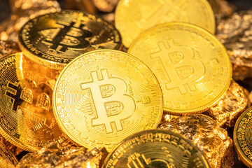 Bitcoins and pieces of gold closeup. Bitcoin against gold, what is the more attractive asset?