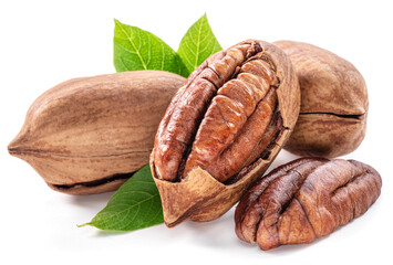 Shelled and cracked pecan nuts with leaves close-up on white background.