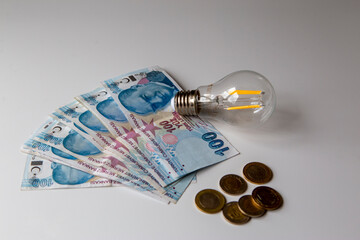 turkish money and light bulb on white background