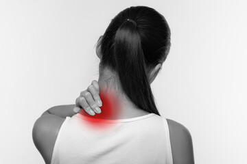 Unrecognizable woman suffering from pain, massaging neck