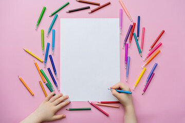  children's hands and blank sheet, pink background, flat lay, top view, space for text
