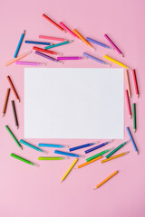 multi-colored felt-tip pens on a pink background, space for text, top view, blank sheet