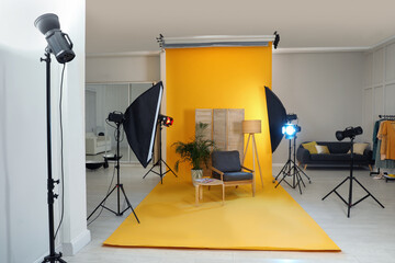 Fototapeta na wymiar Stylish furniture in photo studio with professional equipment