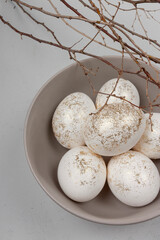 Decorated with golden glitter Easter eggs on plain background
