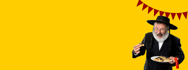 Flyer. Contemporary art collage with portrait of happy senior orthodox jewish man during festival purim. Holiday, celebration, tradition, ad concept.