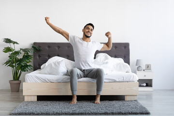 Handsome Happy Arab Guy Waking Up In The Morning, Stretching In Bed