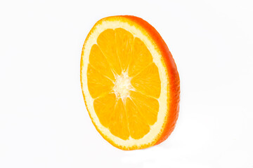 Orange fruit slice isolated on white background closeup. Food background. Flat lay, top view.