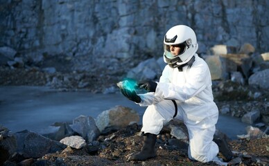Astronaut doing a geological survey on a rocky planet