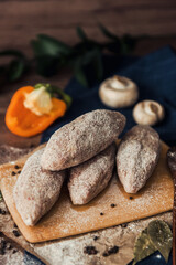 Raw meat cutlets with cabbage on a wooden plate