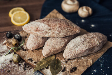 Raw meat cutlets with cabbage on a wooden plate