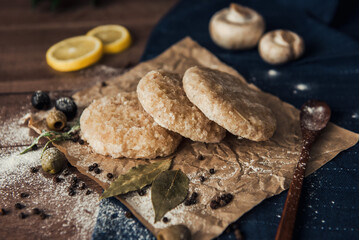 Raw fish cutlets on a wooden plate