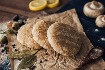 Raw fish cutlets on a wooden plate