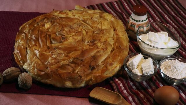 Home made cheese pie with phyllo pastry and eggs. Traditional Bulgarian banitsa with white cheese