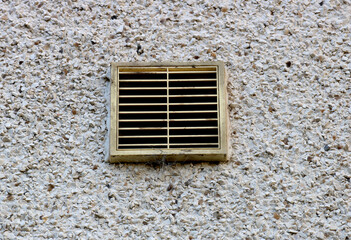 Ventilation Duct Cover on a Roughcast House Rear Wall