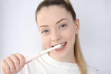 pretty woman brushing her teeth