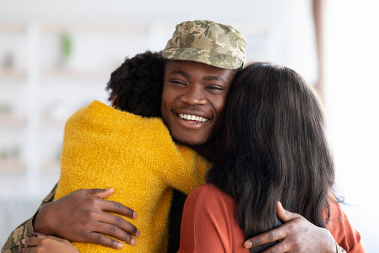 Wife And Daughter Embracing Happy Black Soldier Man After Returning Home