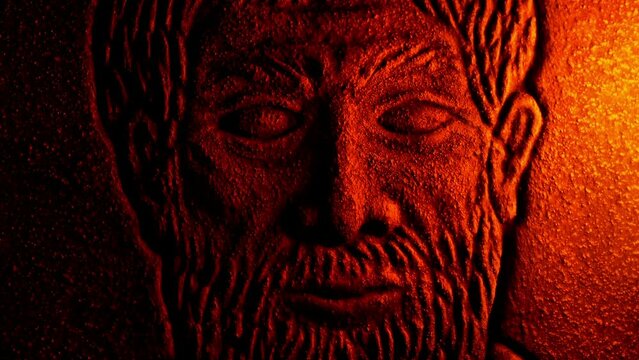 Fire Lights Up Generic Historical Face Carving In Stone