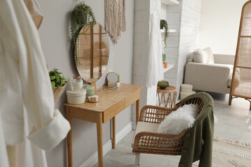 Wooden dressing table with decorative elements in room. Interior design